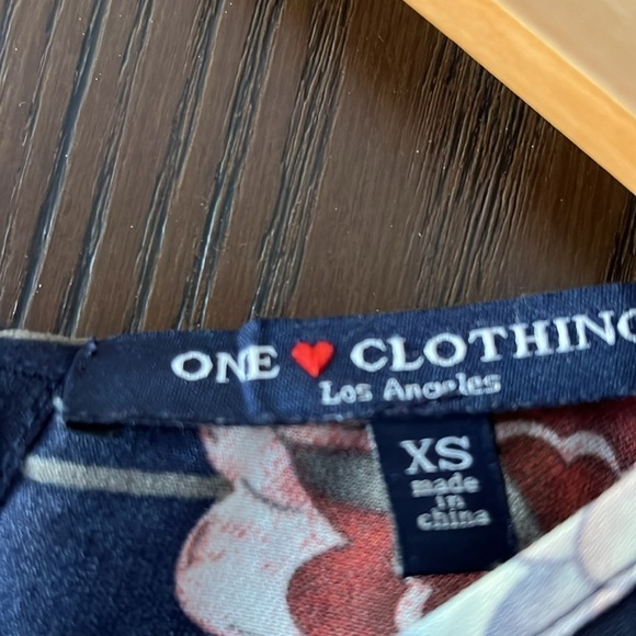 One❤️Clothing navy blue floral long sleeved romper. Size XS. Open V in the back. - Picture 2 of 14